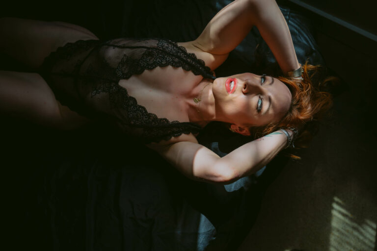A woman laying on a bed in lingerie.